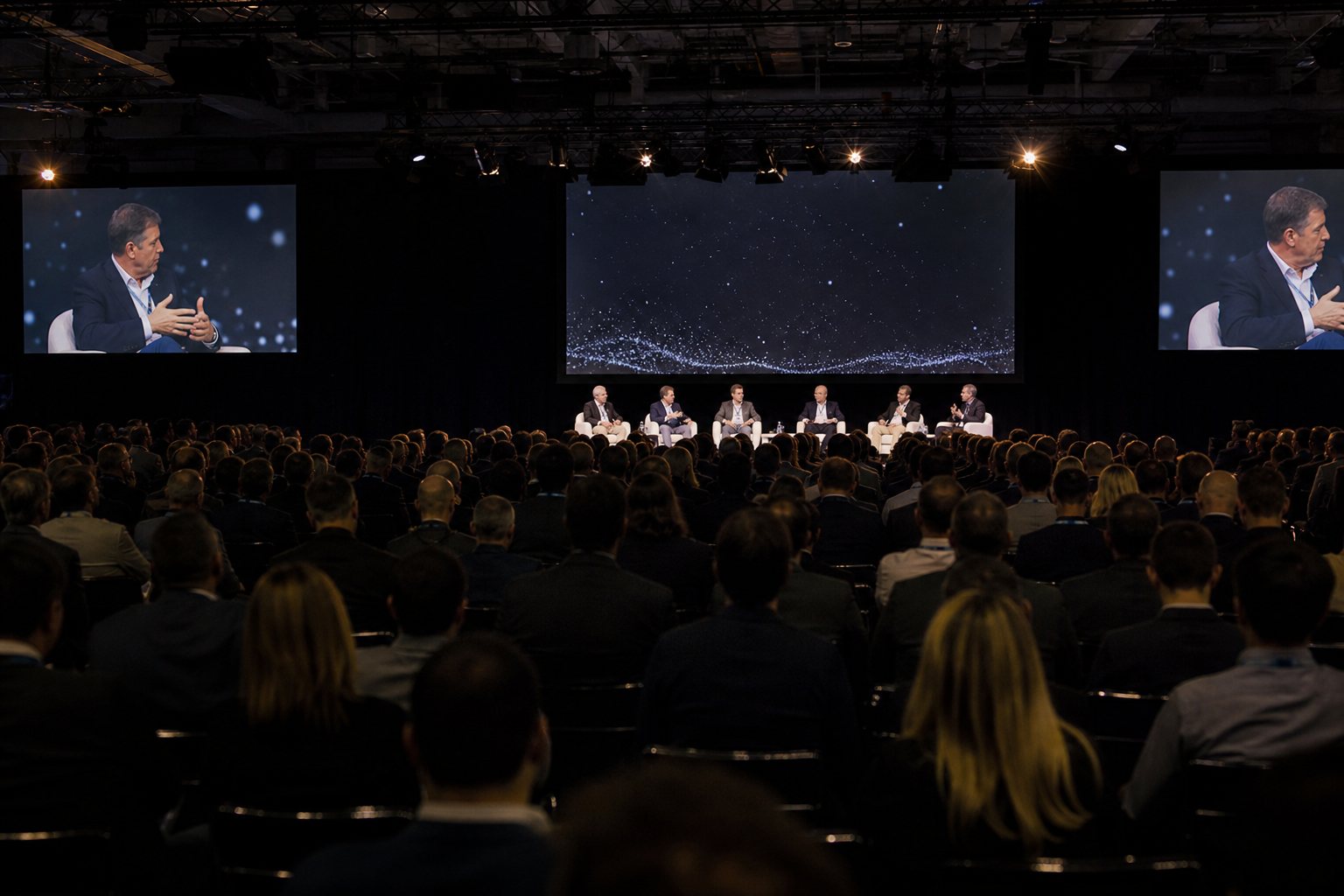 Event agency Wroclaw - a panel discussion on stage with screens and audience